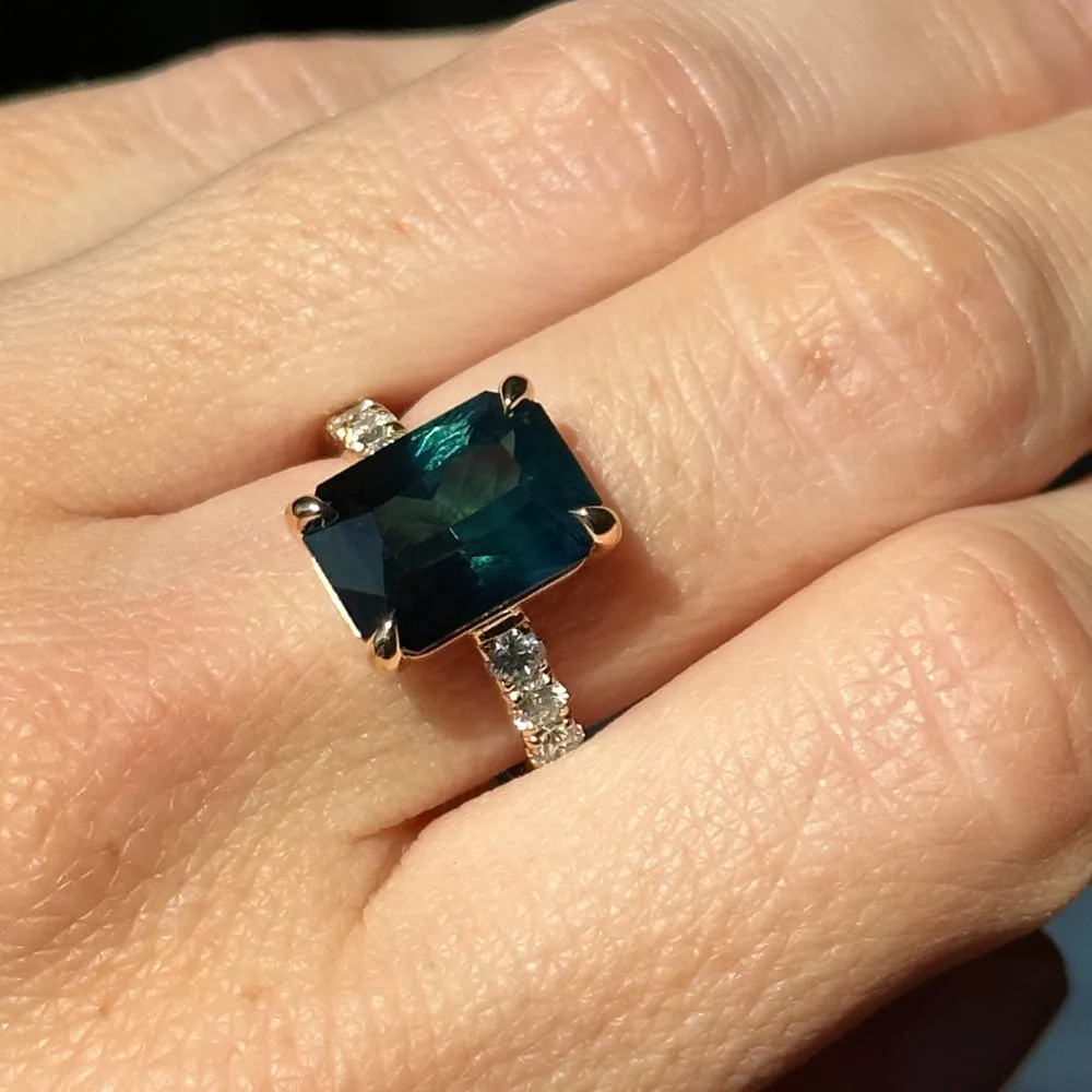 6.12ct Deep Teal Blue Madagascar Radiant Cut Sapphire Solitaire Ring with French Set Diamonds in 18k Yellow Gold