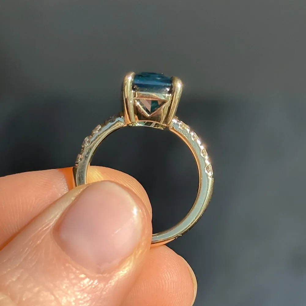 6.12ct Deep Teal Blue Madagascar Radiant Cut Sapphire Solitaire Ring with French Set Diamonds in 18k Yellow Gold